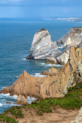 Fototapeta premium liff and stones by the sea, Cabo da Roca, Colares parish, Sintra Municipality, Lisbon District, Portugal