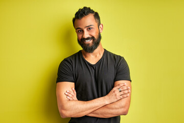 indian arab ith a happy and cool smile on face isolated on green studio background. portrait of...