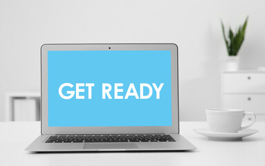 Fototapeta premium Modern laptop with phrase Get Ready on screen in office