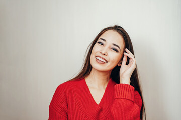 a asian girl in a red jacket on a white background.