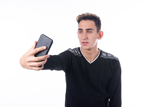 Nice guy takes a selfie. Typing sms and talking on the phone.