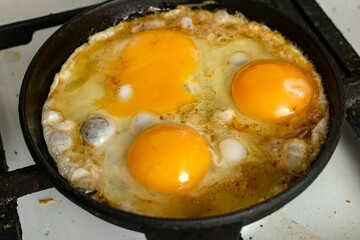 casually cooked scrambled eggs in a skillet