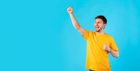 Portrait of happy man screaming and cheering with raised fist