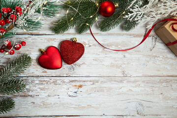 red toys in the form of hearts on a light wooden background. christmas flatley