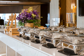 heating trays on buffet line ready for service. breakfast and lunch buffet food catering banquet in hotel or restaurant.
