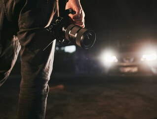 man holds camera. silhouette of videomaker