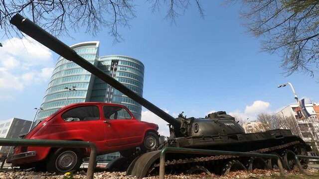 Old car and tank artistic war monument with a blue sky background Time lapse Static Close up Low angle OSIJEK , CROATIA