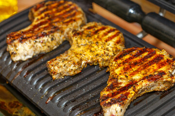 grilling steaks on a flaming grill