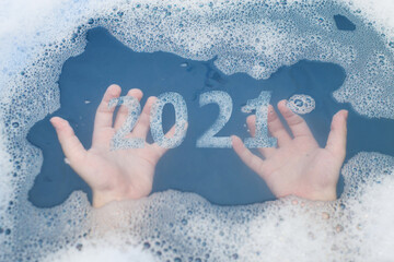Foam numbers 2021. Funny hygiene concept for the whole New Year. Children's hands under soapy water.