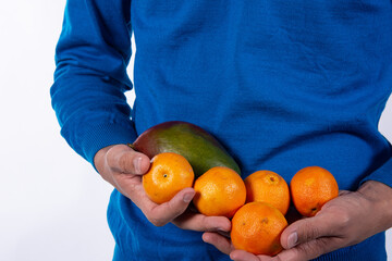 Exotic fruits in the hands of the guy. White background.