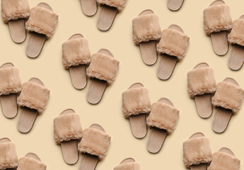 Soft slippers on beige background, top view. Pattern design