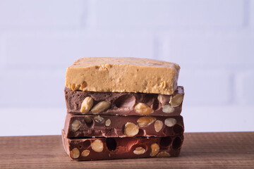 Almond nougat, typical Christmas dessert on wooden background