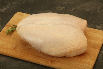 Raw whole chicken breast with skin
