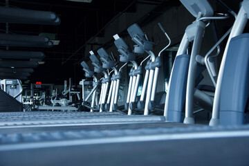 Gym facilities and equipment pointing out the cardio area with treadmills and ellipticals