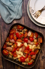 Oven sausage with tomatoes, cheese and crispy bread