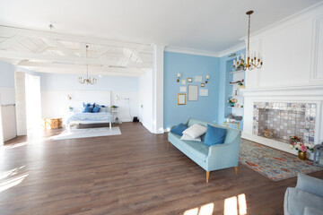 Nice cozy interior of a spacious room in gentle blue tones