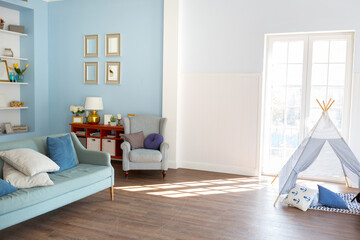 Nice cozy interior of a spacious room in gentle blue tones