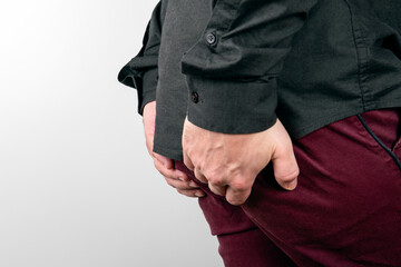 Man holding butt. Diarreha, hemorrhoids and intestines problems