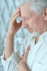 Portrait of thoughtful senior man at home