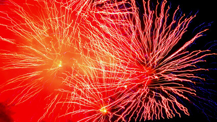 Abstrakte Lichtexplosion am Nachthimmel, Feuerwerk mit roten Rauchschwaden 