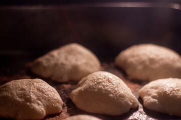 Homemade sweet cookies in stove. Baking cookies in bakery oven.  Cozy and warm home concept.