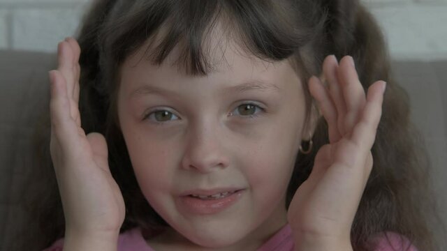 Play peek a boo. A funny nice little girl play peek boo in the room.