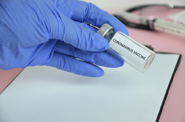 Doctor, nurse or scientist hand in blue nitrile gloves holding flu, measles, coronavirus COVID-19...