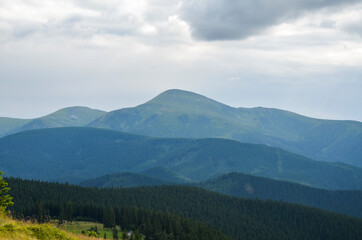 Part of Chornohora range with the highest mountain of Ukraine Hoverla in cloudy summer day. Panoramic view, Carpathian Mountains, Ukraine