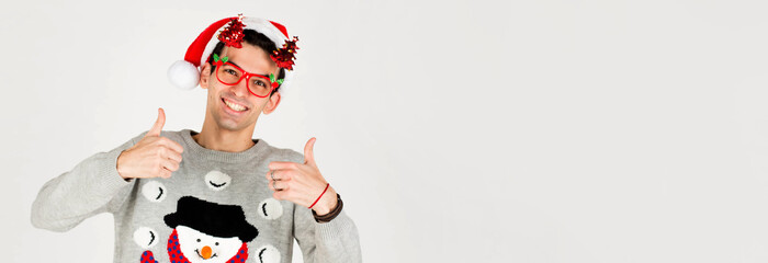Christmas, holidays and celebration. Surprised young man in gray sweater, showing thumbs up in approval, like something great, standing over white background