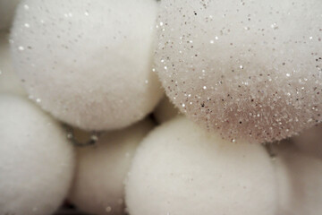 there are a lot of white Christmas round toys nearby