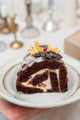 Biscuit roll with cacao and white cream and caramel