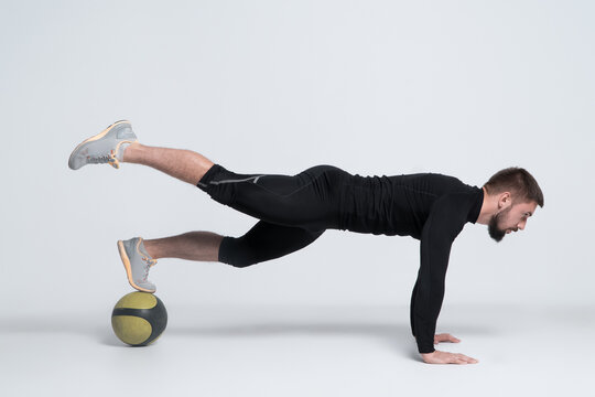 Sport Man Or Bodybuilder Exercising With Medicine Ball On White Background