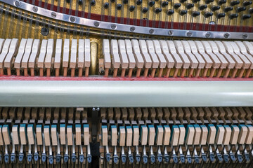 View inside of an old piano, repair and tuning of keyboard musical instruments