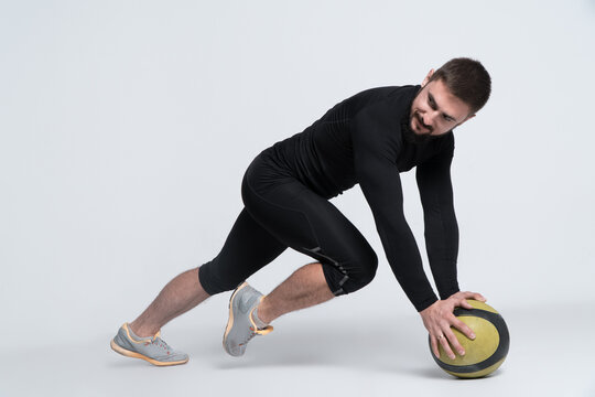 sport man or bodybuilder exercising with medicine ball on white background