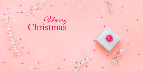 Christmas gift box on pink background with text Merry Christmas