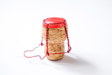Champagne cork with wire cage isolated on white