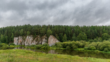 landscape with river, forest and rock on the side