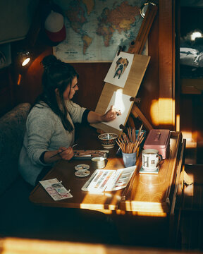 portrait of woman painting down below in yacht