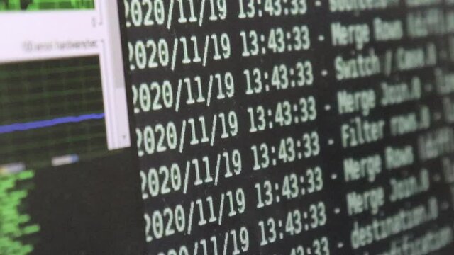 White computer software code moving on a black monitor reflect on glass defocused. Abstract computer hacking in process with rack server base, dynamic text running and flowing on pc screen