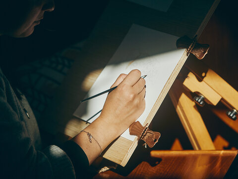 close up of woman painting in the sun