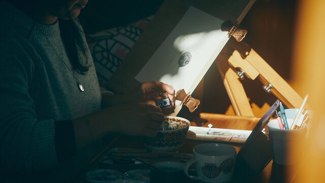 close up of woman sharpening pencil in the sun