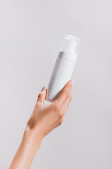 cropped view of woman holding cleansing foam isolated on grey, stock image