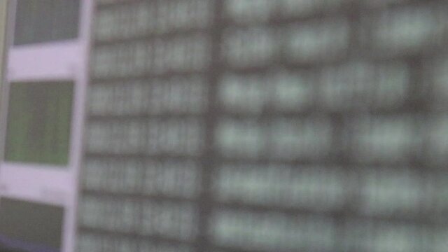 White computer software code moving on a black monitor. Computer hacking in process, dynamic text running and flowing on pc screen.