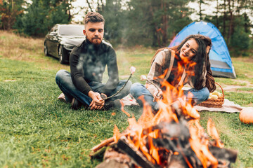 Couple in love have fun outside the city near the fire away from the hustle and bustle