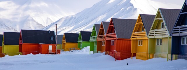colorful houses in Longyearbyen, Spitsbergen / Svalbard during a cruise on an old sail ship early spring when the landscape was still in winter scenes with lots of snow and ice