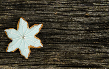 Christmas snowflake iced gingerbread cookies on a old textured wood background. Home made. Food backgrund.