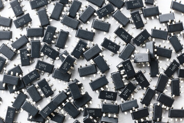 Smd components abstract background. Small surface mound chip semiconductor arranged randomly. Electronic component macro shoot isolated on white background.