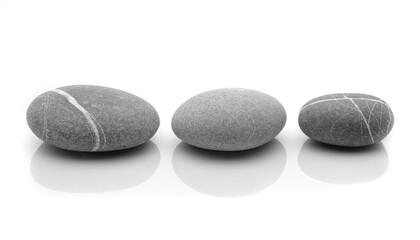 Fototapeta na wymiar Three fluvial grey stones, lined up on a white reflective background 