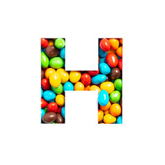 Letter H of English alphabet of multicolored candies and paper cut isolated on white. Typeface for festive design