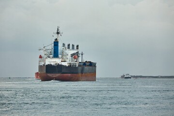 Fototapeta premium Large crude oil tanker ship leaving the port of Rotterdam to the North Sea